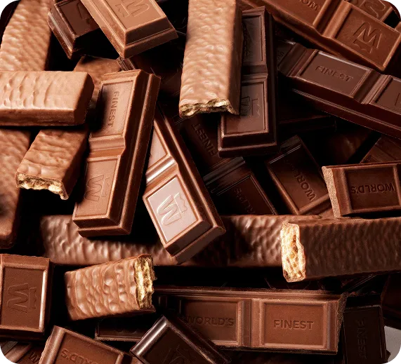 A pile of unwrapped World's Finest Chocolate bars, including wafer bars